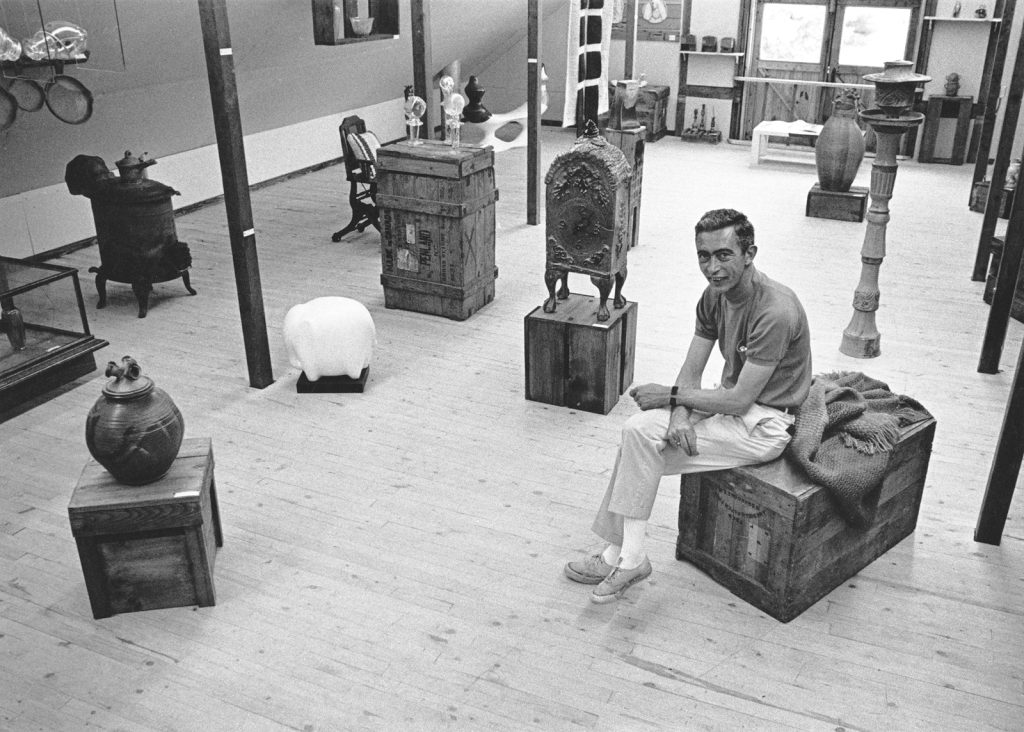 Bill Brown pictured in the The Barns studios with work by Penland resident artists ca. late 60s early 70s. Courtesy of Penland School of Crafts Archives.