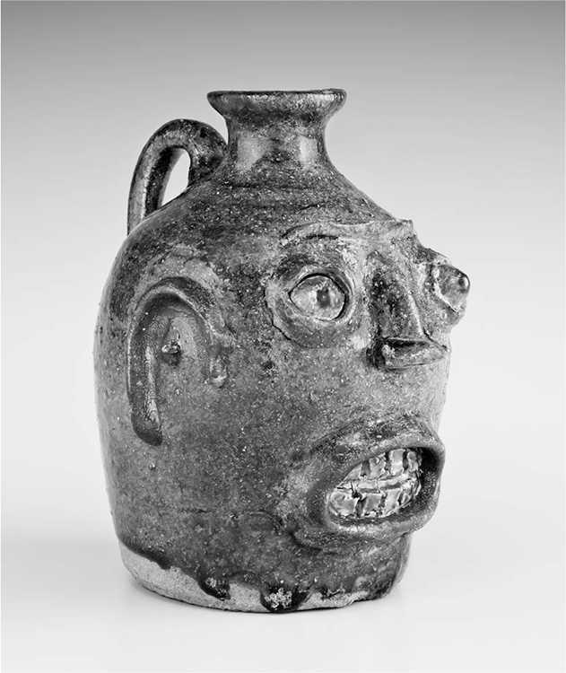 Edgefield District, South Carolina Face Jug, ca. 1862, alkaline glazed stoneware with kaolin inserts, 6⅝ × 5⅛ in. (16.83 × 13.02 cm.). Photograph by Jim Wildeman, courtesy of the Chipstone Foundation 2012.4.